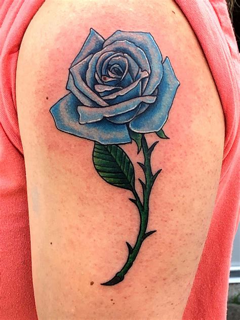 blue rose tattoo on dark skin